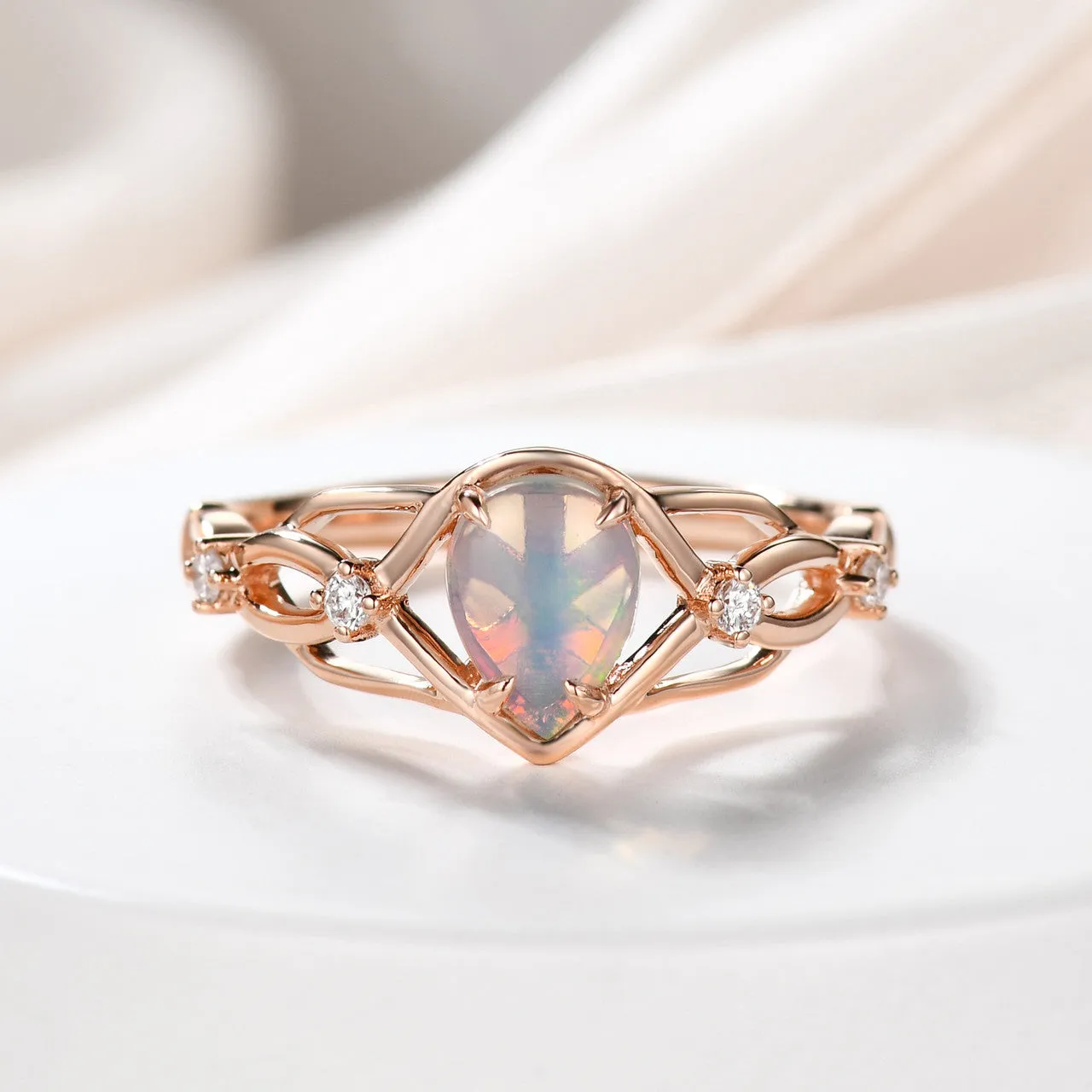 Australian opals Celtic style engagement ring set with 4 little diamonds.