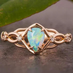 Australian opals Celtic style engagement ring set with 4 little diamonds.