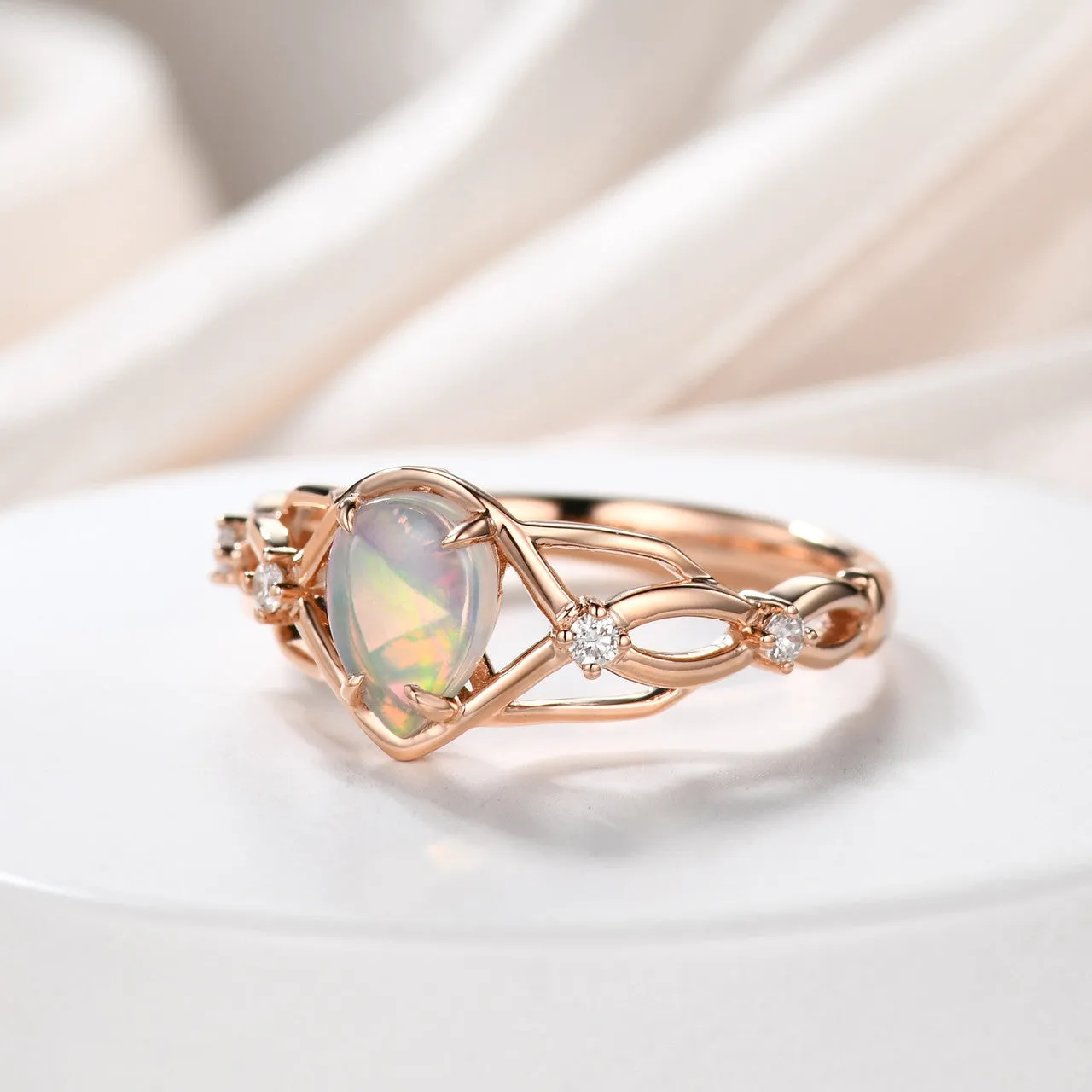 Australian opals Celtic style engagement ring set with 4 little diamonds.