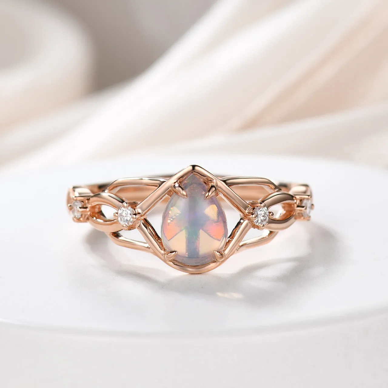 Australian opals Celtic style engagement ring set with 4 little diamonds.