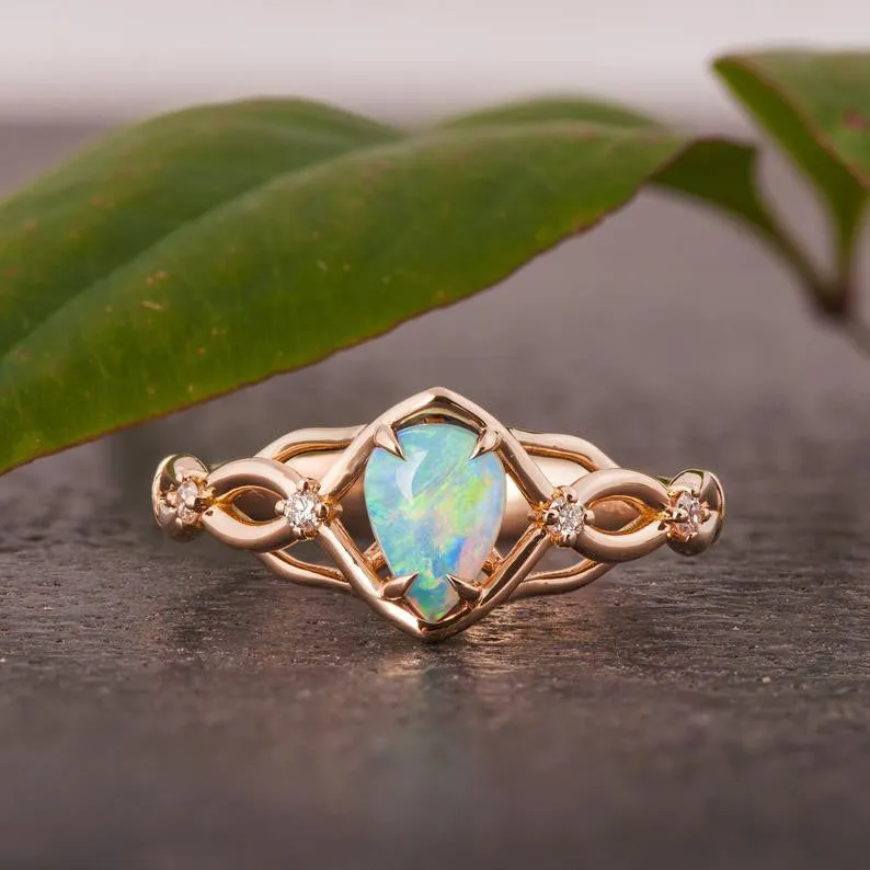 Australian opals Celtic style engagement ring set with 4 little diamonds.